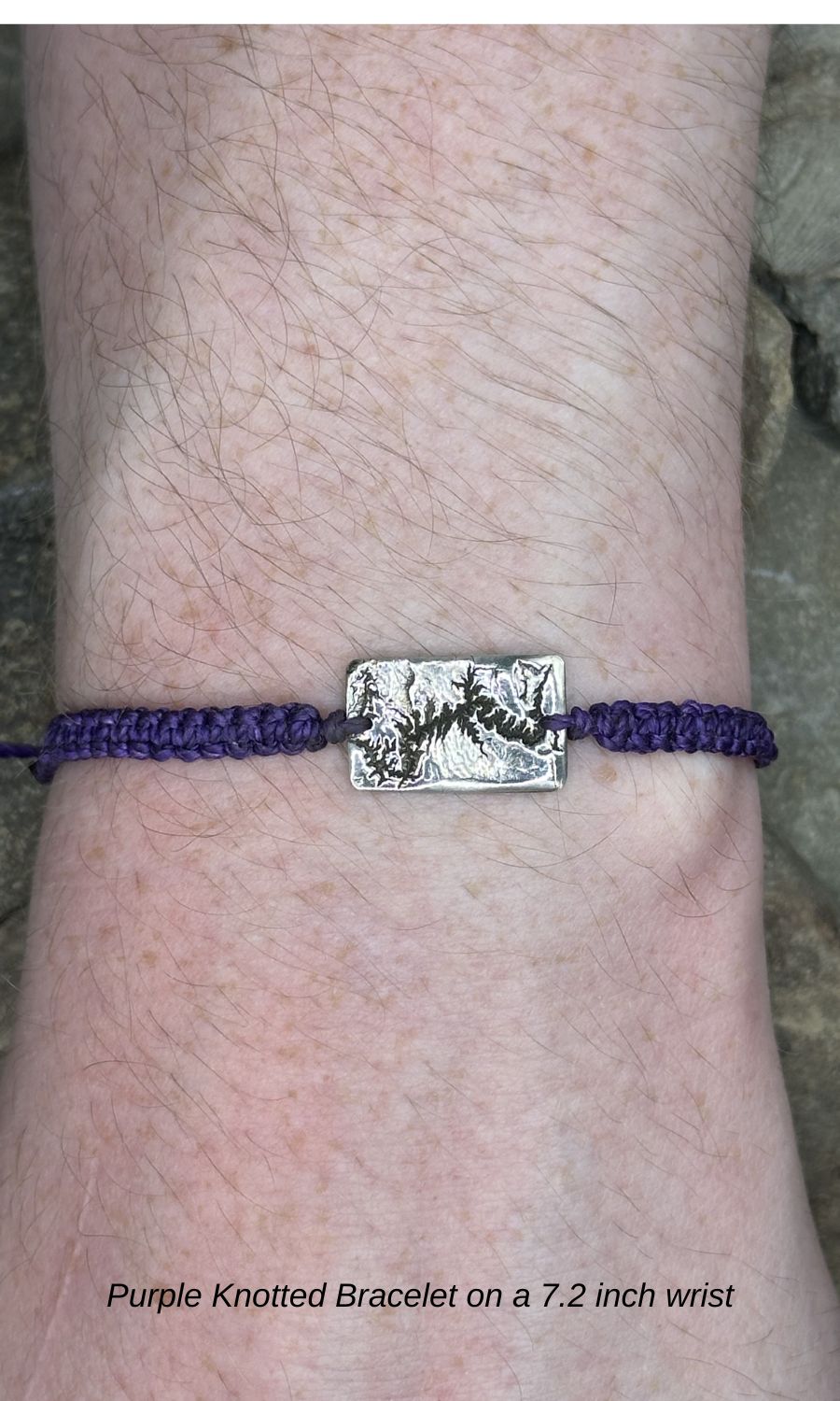 A handcrafted silver bracelet showing the topographic contours of the Grand Canyon – front view knotted bracelet on 7.2 inch wrist