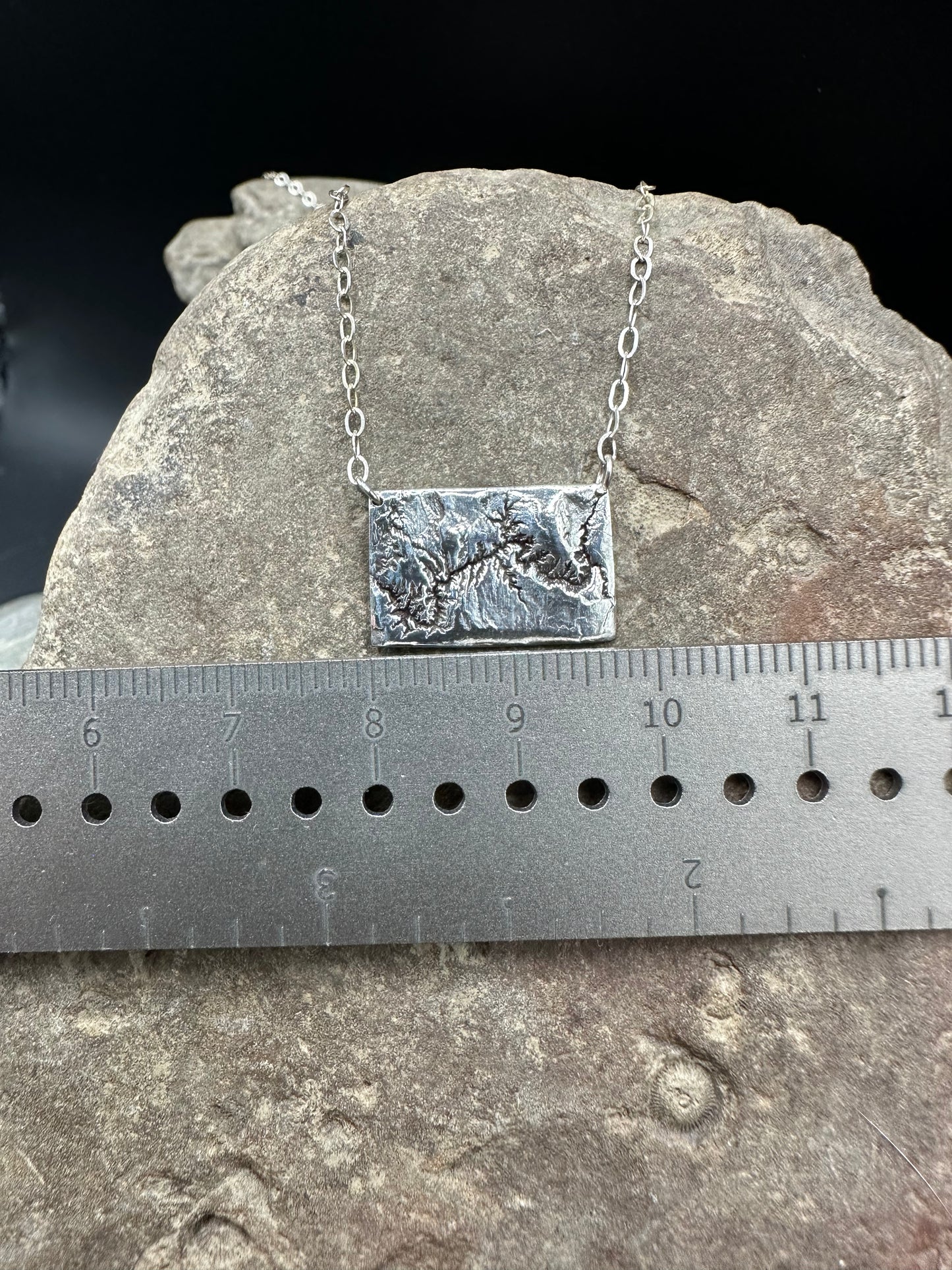 Picture of the 17 mm width of the silver handcrafted necklace showing the topographic details of the Grand Canyon in Arizona