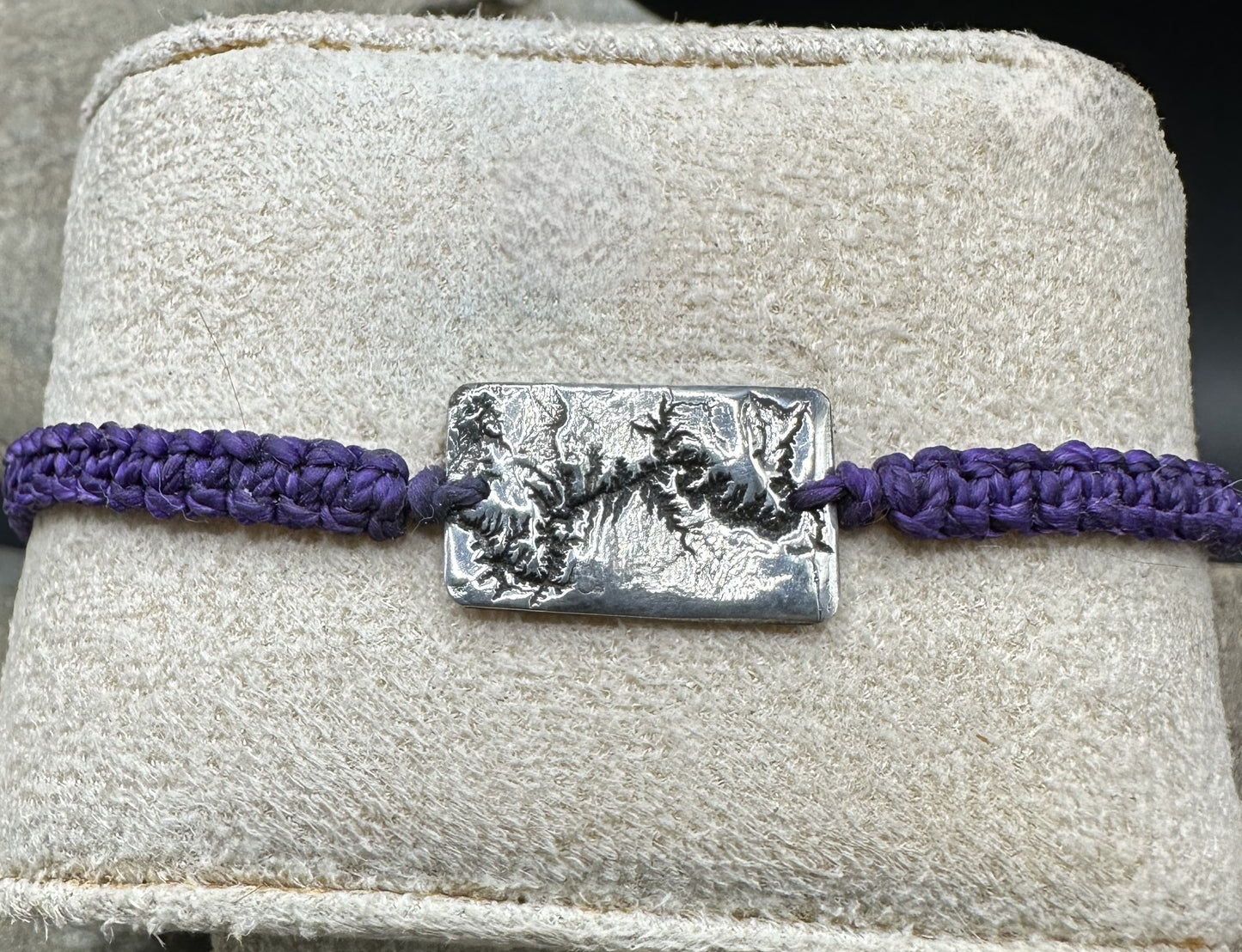 A handcrafted silver bracelet showing the topographic contours of the Grand Canyon – front view knotted bracelet
