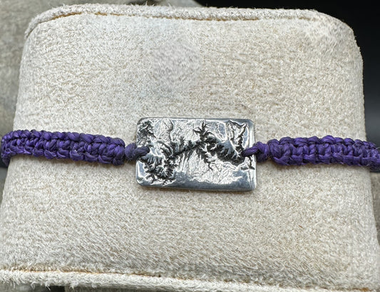 A handcrafted silver bracelet showing the topographic contours of the Grand Canyon – front view knotted bracelet