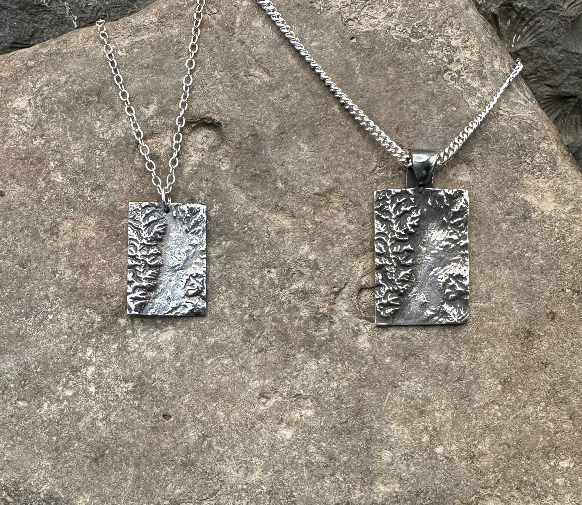 Pair of 3D fine silver pendants of Grand Teton National Park.  Accurately displays the elevations and contours of the park in two different sizes.