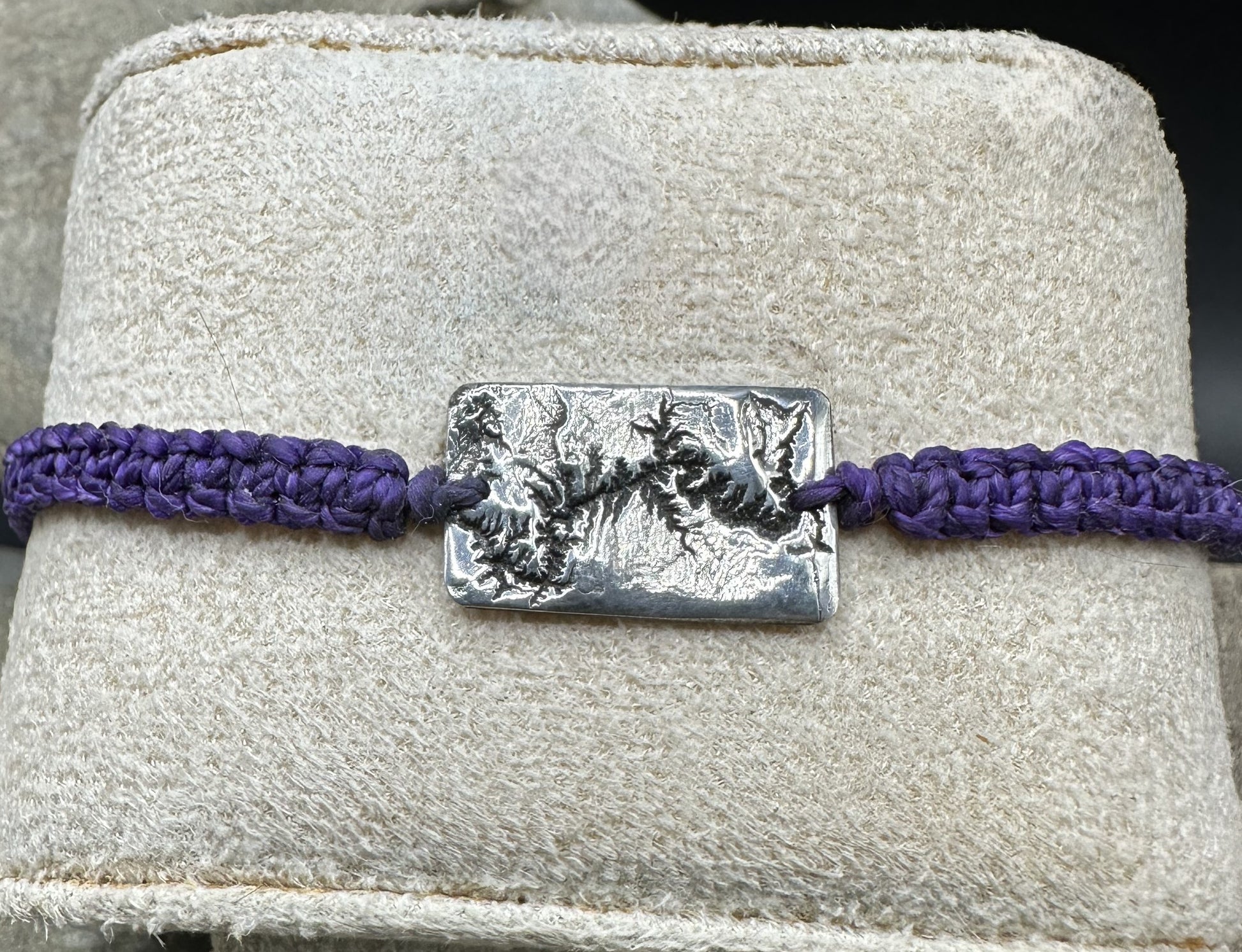 A handcrafted silver bracelet showing the topographic contours of the Grand Canyon – front view knotted bracelet