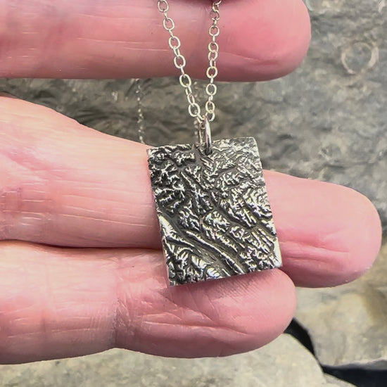 Video of 3D fine silver pendants
 of Alberta Canada's Banff National Park.  Accurately displays the elevations and contours of the park in two different sizes.
